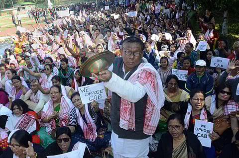A man plays cymbals as protestors gather during an agiatation against the passing of Citizenship Amendment Bill in Dibrugarh Saturday Dec. 14 2019. (Photo | PTI)