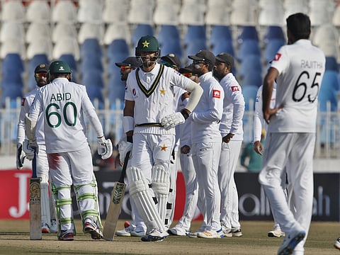 Pakistani batman Shan Masood, center, reacts while Sri Lankan players celebrate his dismissal during the fifth day of the first cricket test match between Pakistan and Sri Lanka, in Rawalpindi, Pakistan, Sunday, Dec. 15, 2019. (Photo | AP)