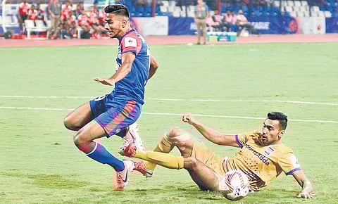 Bengaluru FC’s Ashique Kuruniyan (left) and Sarthak Golui of Mumbai City FC vie for the ball during their ISL clash in Bengaluru on Sunday  | shriram bn