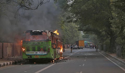 Smoke billows from a passenger bus after it was set on fire during a protest against citizen amendment bill in New Delhi on December 15,2019. (Photo | Arun Kumar, EPS)