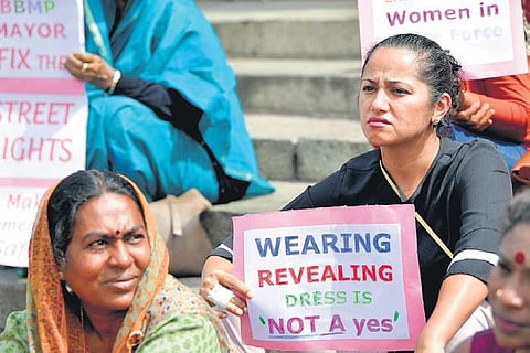 A woman holds a placard while protesting and expressing concern about  women’s safety at the Town Hall, in Bengaluru on Sunday | meghana Sastry