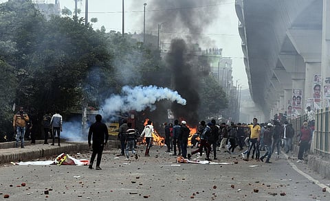 Brick-bats lie on a road as anti-CAA Citizenship Amendment Act protestors clash with the police at Seelampur in New Delhi Tuesday Dec. 17 2019. (Photo | EPS/Parveen Negi)