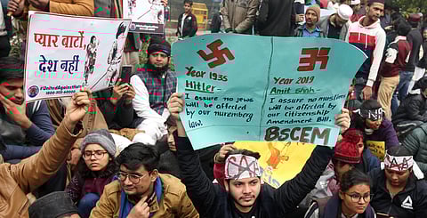 Protestors hold placards during a demonstration against the Citizenship Amendment Act near Red Fort in New Delhi Thursday. (Photo | Shekhar Yadav, EPS)