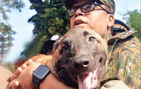 State police chief Loknath Behera holding a dog newly inducted into the K9 squad at the state police headquarters on Monday | Vincent Pulickal