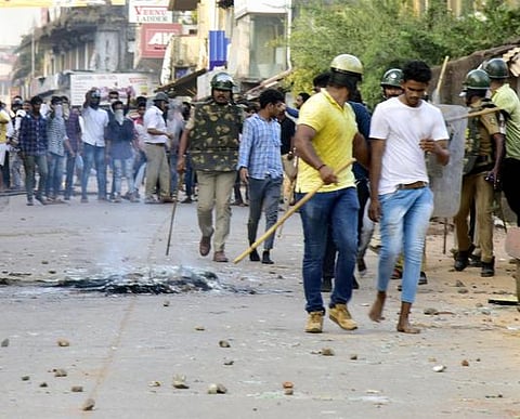 Protestors being dispersed by Mangaluru police on Thursday. (Photo | EPS)