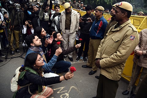 Protestors offer roses to police personnel during a demonstration against the Citizenship Amendment Act at Mandi House in New Delhi Thursday Dec. 19 2019. (Photo | Parveen Negi/EPS)