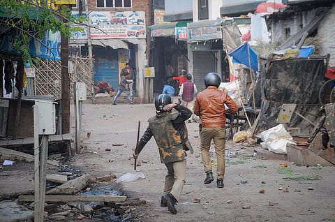 Police personnel pelt stones during a protest against the Citizenship Amendment Act at Babu Purwa in Kanpur Friday Dec. 20 2019. (Photo | PTI)