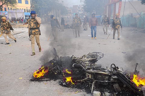 Smoke billows out of a charred vehicle as a protest against the Citizenship Amendment Act turned violent at Babu Purwa in Kanpur Friday Dec. 20 2019. (Photo | PTI)