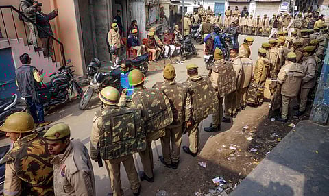 Police personnel guard a street during protests against Citizenship Amendment Act CAA in Varanasi Saturday Dec. 21 2019. (Photo | PTI)
