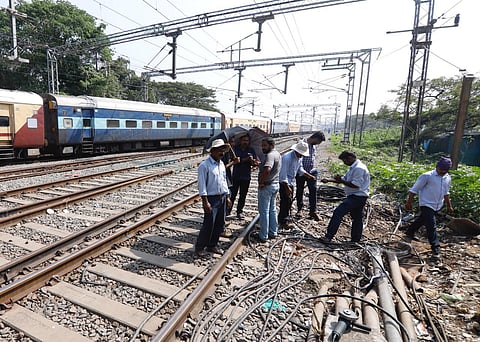 Railway officials trying to clear the cables which was damaged in fire accident near Ernakulam junction. (Photo | Arun Angela, EPS)
