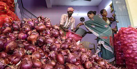 Workers repacking imported onions from Egypt in Tiruchy. (Photo | M K Ashok Kumar, EPS)