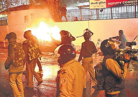Police and media personnel outside the DCP Central’s office in Daryaganj where protesters set ablaze a car on Friday evening (File Photo| EPS, Shekhar Yadav)