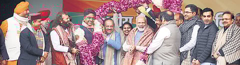 Prime Minister Narendra Modi along with BJP leaders Manoj Tiwari, Meenakshi Lekhi, Harsh Vardhan, Vijay Goel, Hansraj Hans, Gautam Gambhir and others during a rally at Ramlila Maidan, in New Delhi on Sunday. (Photo | Shekhar Yadav)