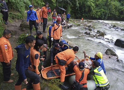 In this photo released by the National Search And Rescue Agency (BASARNAS), rescuers remove the body of a victim of a bus accident in Pagaralam, Indonesia, Tuesday, Dec. 24, 2019. (Photo | AP)