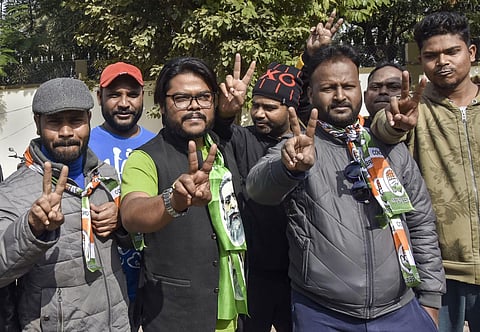 Jharkhand Mukti Morcha (JMM) and Congress Party workers flash victory sign during the counting of votes for Jharkhand Assembly Elections results in Ranchi Monday Dec. 23 2019. (Photo | PTI)
