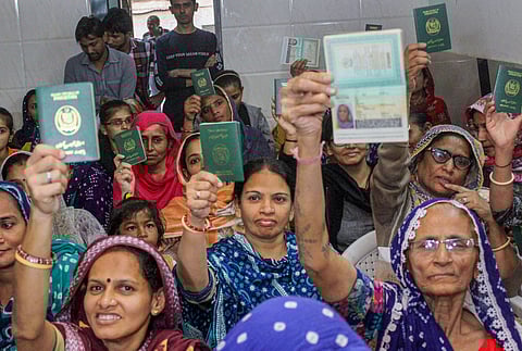 Hindu refugees who migrated from Sindh province of Pakistan display their passports as they support the Citizenship Amendment Act in Ahmadabad, Monday, Dec. 23, 2019. (Photo | PTI)