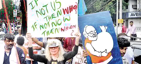 A Norwegian woman takes part in the cine artists’ rally against NRC and CAA