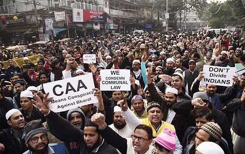 Demonstrators hold placards and raise slogans during a protest against the Citizenship Amendment Act (CAA) and National Register of Citizens (NRC), at Jama Masjid in New Delhi on Friday. (Photo | Parveen Negi, EPS)