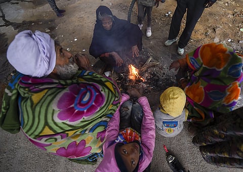 People warm themselves around a bonfire on a cold wintry morning in New Delhi Friday Dec. 27 2019. (Photo | PTI)