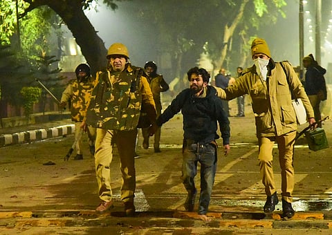 Police take away a student after clashes following protests over Citizenship Amendment Act on the campus of Aligarh Muslim University (File Photo | PTI)