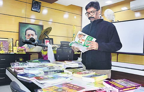 Jharkhand Chief Minister (designate) Hemant Soren reads a book at his residence in Ranchi on Saturday. (Photo | PTI)