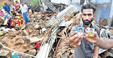 A relative showing photos of a mother and daughter killed in the wall collapse | A RAJA CHIDAMBARAM