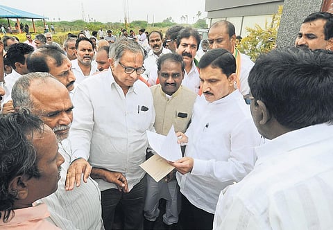 Villagers give a representation to BJP Rajya Sabha member Sujana Chowdary when he met agitating Amaravati villagers at Uddandarayunipalem on Sunday I Prasant Madugula