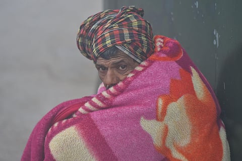 A man wraps a blanket to protect himself from cold wave conditions during a foggy morning in New Delhi Monday Dec 30 2019. (Photo | PTI)
