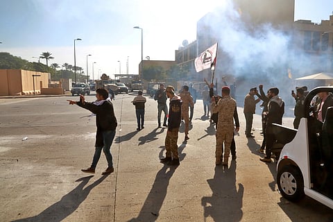 U.S. soldiers fire tear gas to stop protesters inside U.S. embassy compound, in Baghdad, Iraq, Tuesday, Dec. 31, 2019. (Photo | AP)