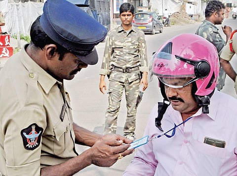 Police check ID cards and documents of people who are going to Secretariat  at Velagapudi on Monday (Photo | Prasant Madugula/EPS)