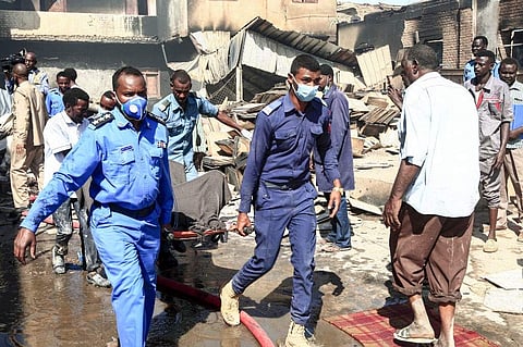 Members of the Sudanese Civil Defence transport the bodies of victims of a fire at a tile manufacturing unit in an industrial zone in north Khartoum. (Photo | AFP)
