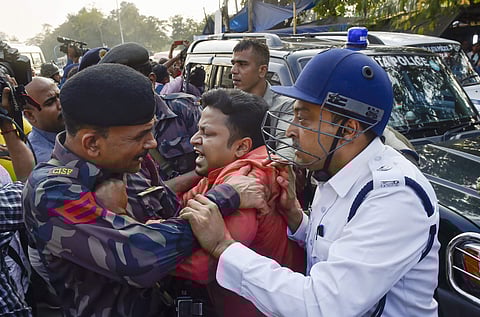 Police detain BJP leader Anupam Hazra and his CISF bodyguard who tried to save him during a Hindu Jagaran Manch protest rally in Kolkata Wednesday Dec. 4 2019. (Photo | PTI)