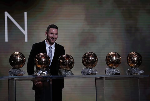 Argentine Lionel Messi poses with his six golden balls during the Ballon d'Or award ceremony in Paris. Messi said he hoped to carry on undimmed by age after claiming a record Golden Ball at the age of 32. (Photo | AP)
