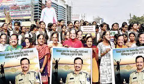 People wearing masks of Cyberabad Commissioner VC Sajjanar and KCR in Karimnagar on Friday, expressing their happiness over the encounter deaths in Hyderabad