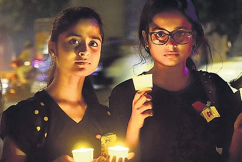 Residents of Bengaluru hold a candlelight vigil demanding justice for victims of sexual assaults on Friday (Photo | Pandarinath B, EPS)
