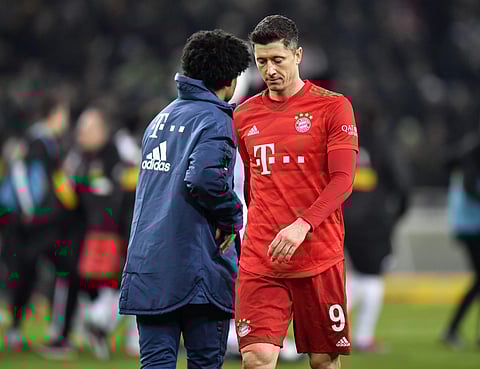Bayern's Robert Lewandowski, right, leave the pitch disappointed beside Bayern's Serge Gnabry, left, after losing the German Bundesliga soccer match between Borussia Moenchengladbach and Bayern Munich at the Borussia Park in Moenchengladbach, Germany, Sat