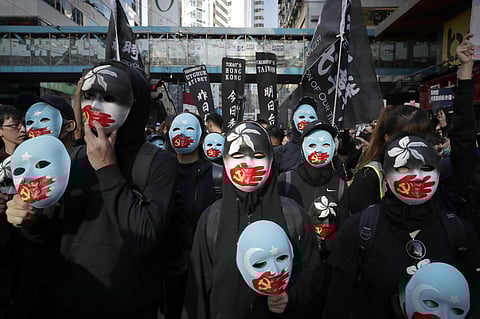 Masked pro-democracy protesters march on a street in Hong Kong, Sunday, Dec. 8, 2019. (Photo | AP)
