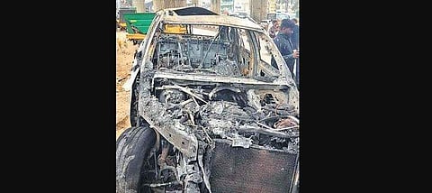 The burnt remains of the car that caught fire in Peenya, Bengaluru, on Saturday. (Photo | EPS)