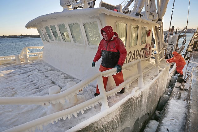 Crew members prepare to tie off as the ice covered fishing boat, Buzzards Bay, arrives at New Bedford, Massachusetts harbor due to the extreme cold conditions.  (Photo | AP)