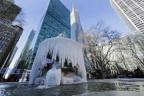 Pedestrians pass a frozen water fountain at Bryant Park in New York. The polar vortex that brought many cities to a standstill was expected to come to a swift end with a rapid thaw that experts say could be unprecedented. But the sudden swing from long jo
