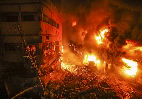 Flames rise from a fire in a densely packed shopping area in Dhaka. (AP photo)