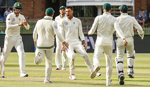 South Africa's Duanne Olivierto, centre, reacts with teammates after dismissing Sri Lanka's batsman Dimuth Karunaratne for 19 runs on day two of the second cricket test match between South Africa and Sri Lanka at St. George's Park in Port Elizabeth