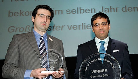 World Champion Vishwanathan Anand (R) and Vladimir Kramnik (L) show the trophies during the winner ceremony of the Chess World Championship in the Art and Exhibition Hall of the Federal Repblic of Germany in Bonne. (File | AP)