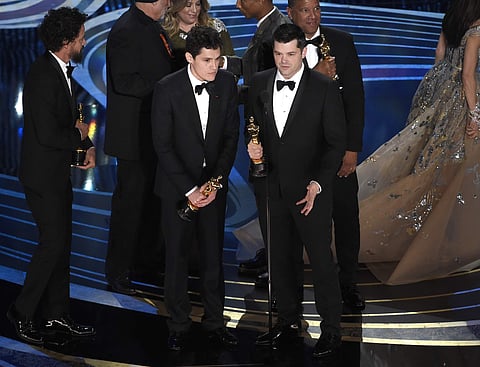 Phil Lord, left, and Christopher Miller accept the award for best animated feature film for 'Spider-Man: Into the Spider-Verse' at the Oscars. (Photo | AP)