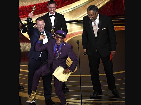 Spike Lee, foreground center, Charlie Wachtel, from left, David Rabinowitz and Kevin Willmott accept the award for best adapted screenplay for 'BlacKkKlansman' at the Oscars. (Photo | AP)
