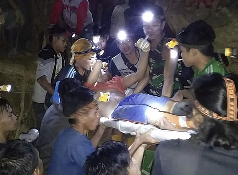 Indonesian Search And Rescue Agency (BASARNAS) rescuers evacuate a survivor from a collapsed gold mine in Bolaang Mongondow, North Sulawesi, Indonesia. (Photo | AP)