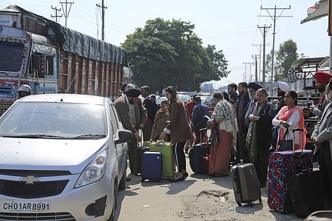 Stranded passengers stand outside an airport after it was closed for civilians operations amid tension along the border with Pakistan in Jammu, India, Wednesday, Feb. 27, 2019. (Photo | AP)