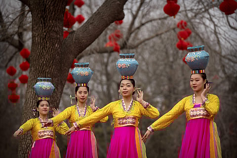 Dancers in traditional ethnic clothing perform at a temple fair at Longtan Park in Beijing. (Photo | AP)
