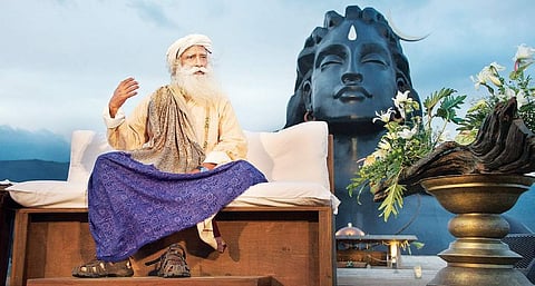 Sadhguru in front of the 34-metre tall Adiyogi statue at the Isha Yoga Centre in Coimbatore | Express