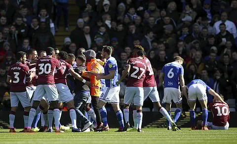 Fan is removed after attacking Aston Villa's Jack Grealish, right, on the pitch during the Sky Bet Championship soccer match at St Andrew's Trillion Trophy Stadium, Birmingham. (Photo | AP)